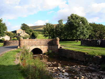 Bridge and Downham Beck with Pendle Hill in the background